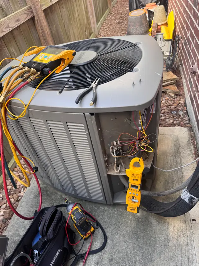 Lennox condenser with the service panel removed and the contactor exposed
